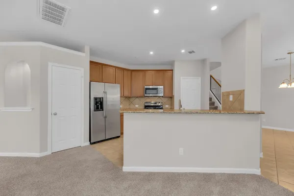 a kitchen with stainless steel appliances a refrigerator sink and cabinets