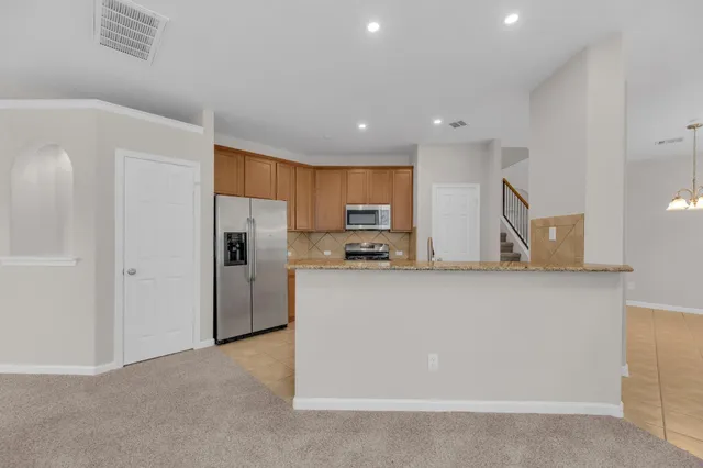 a kitchen with stainless steel appliances a refrigerator sink and cabinets