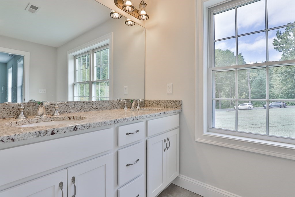 492 Northfield Road Lunenburg, MA 01462 - Photo 15 of 39 a bathroom with a granite countertop sink mirror and next to a window