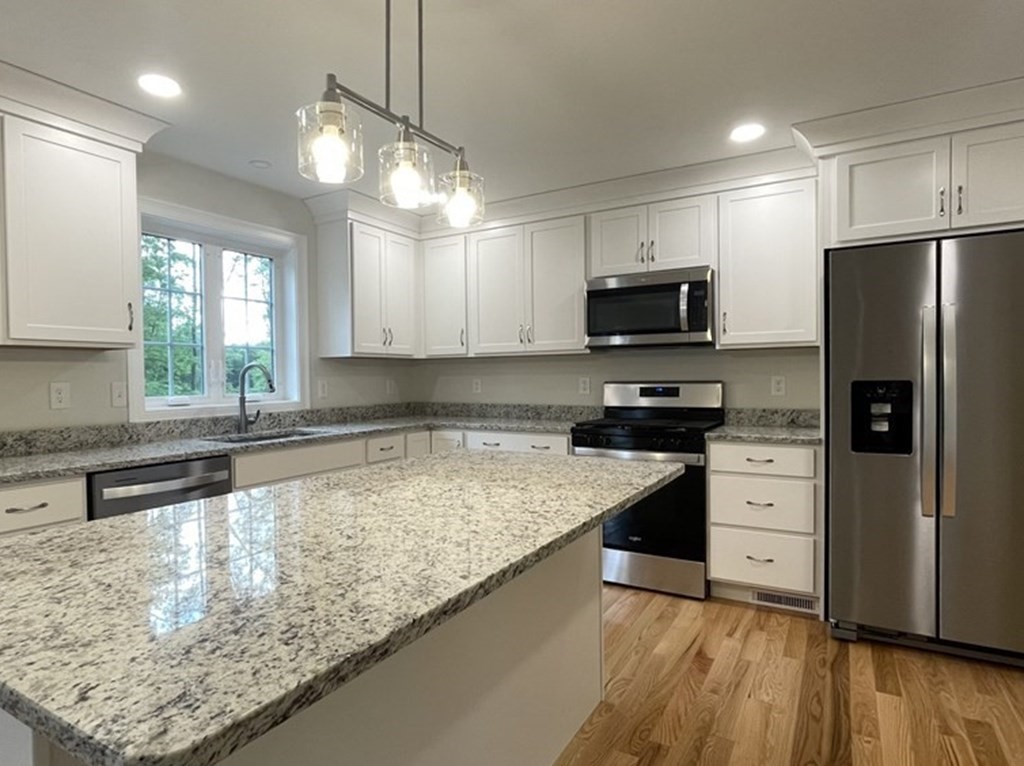492 Northfield Road Lunenburg, MA 01462 - Photo 2 of 39 a kitchen with granite countertop a refrigerator oven a sink dishwasher and a stove with wooden floor