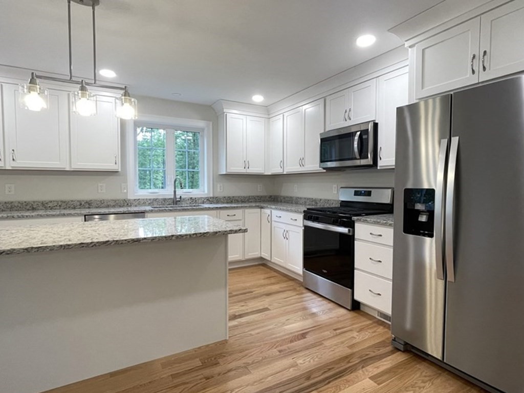 492 Northfield Road Lunenburg, MA 01462 - Photo 5 of 39 a kitchen with stainless steel appliances a stove a sink dishwasher a refrigerator and a microwave