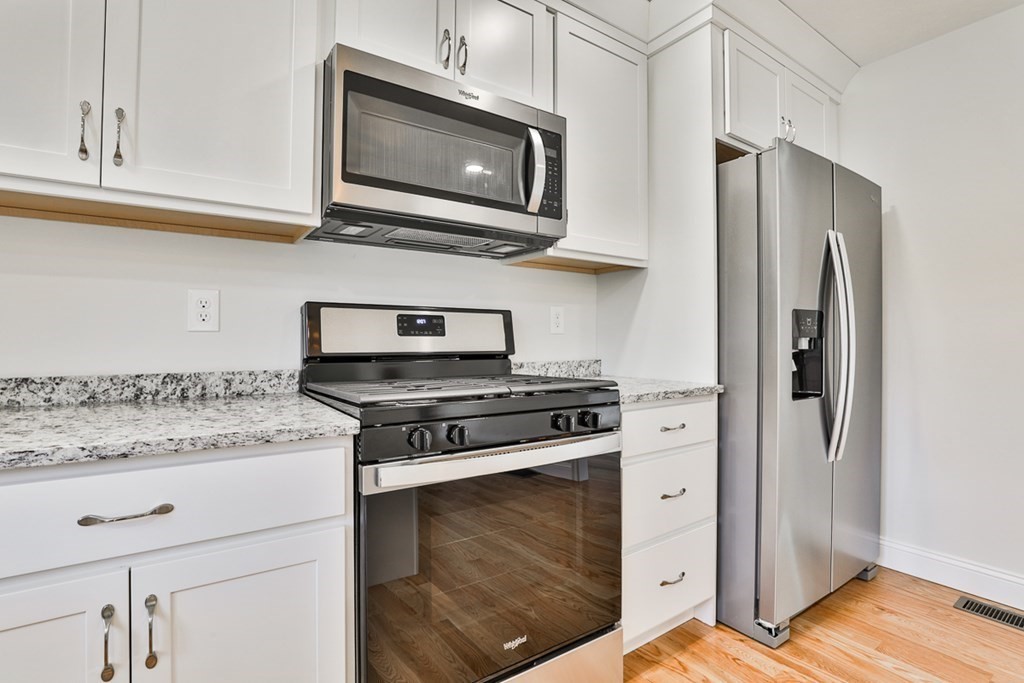 492 Northfield Road Lunenburg, MA 01462 - Photo 8 of 39 a kitchen with stainless steel appliances granite countertop a stove microwave and refrigerator