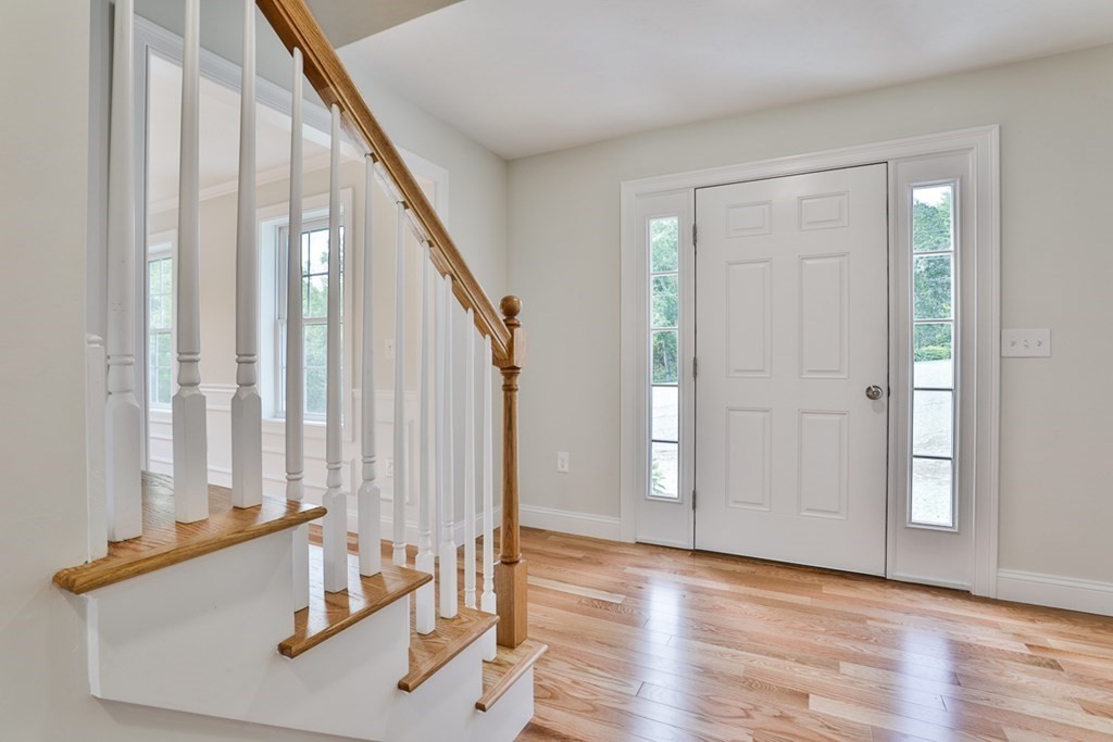 492 Northfield Road Lunenburg, MA 01462 - Photo 9 of 39 a view of a hallway with wooden floor and staircase