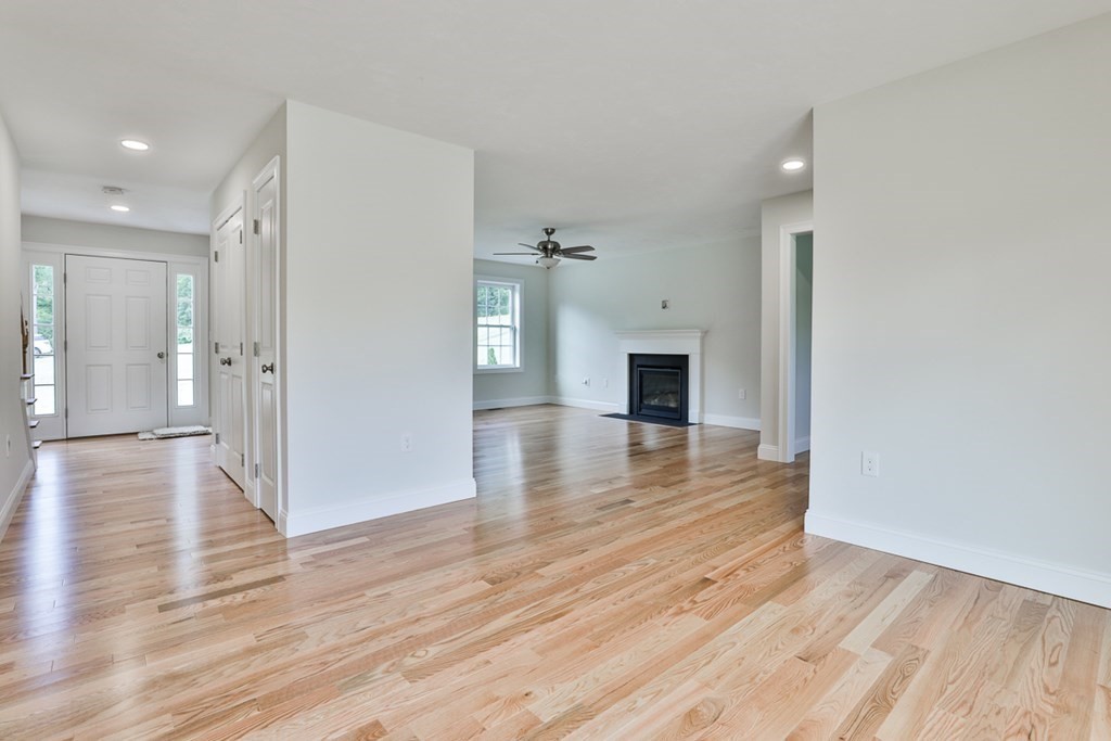 492 Northfield Road Lunenburg, MA 01462 - Photo 10 of 39 a view of empty room with wooden floor and fireplace