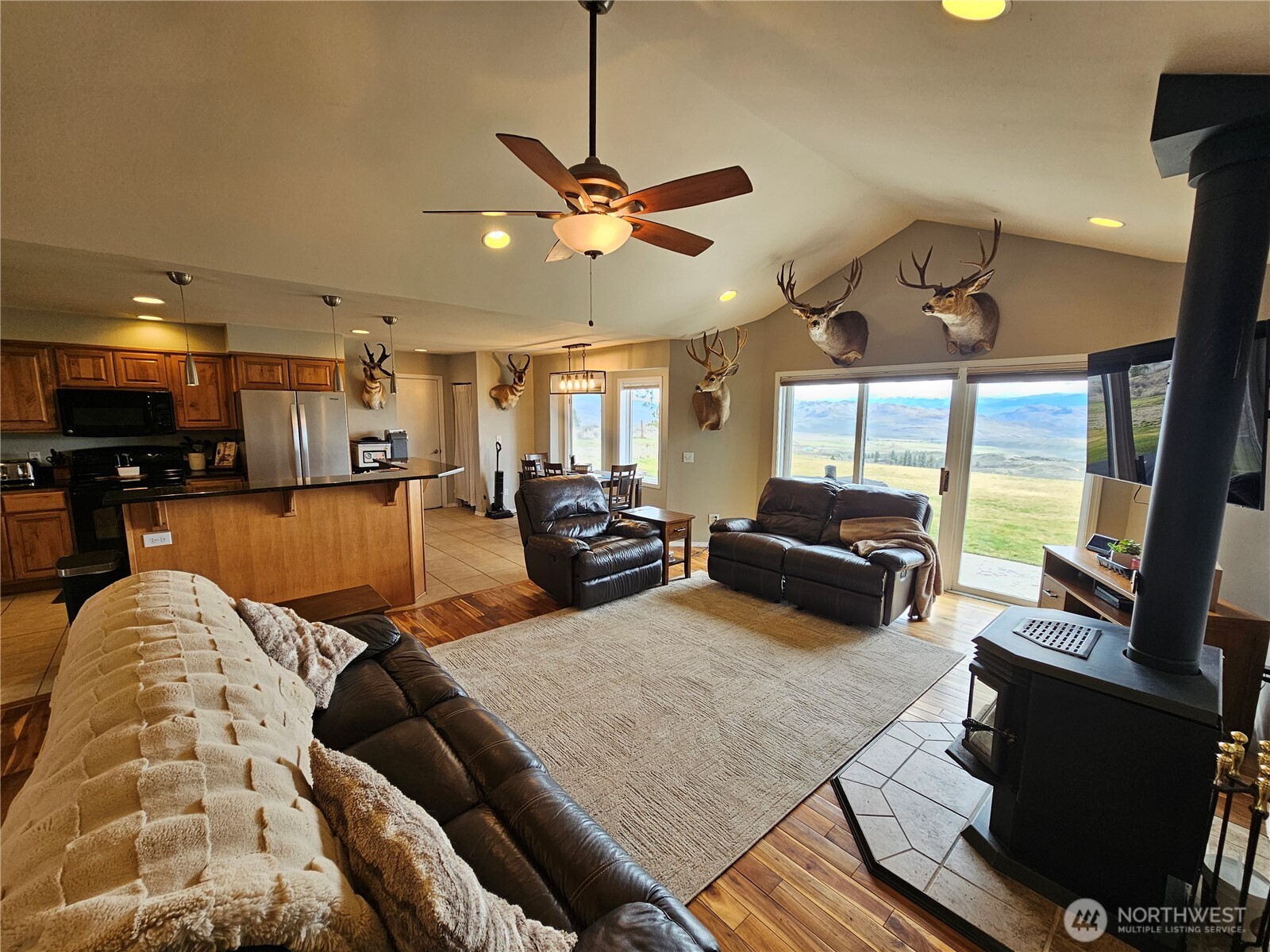 711 Havillah Road Tonasket, WA 98855 - Photo 14 of 40 a living room with furniture kitchen view and a large window