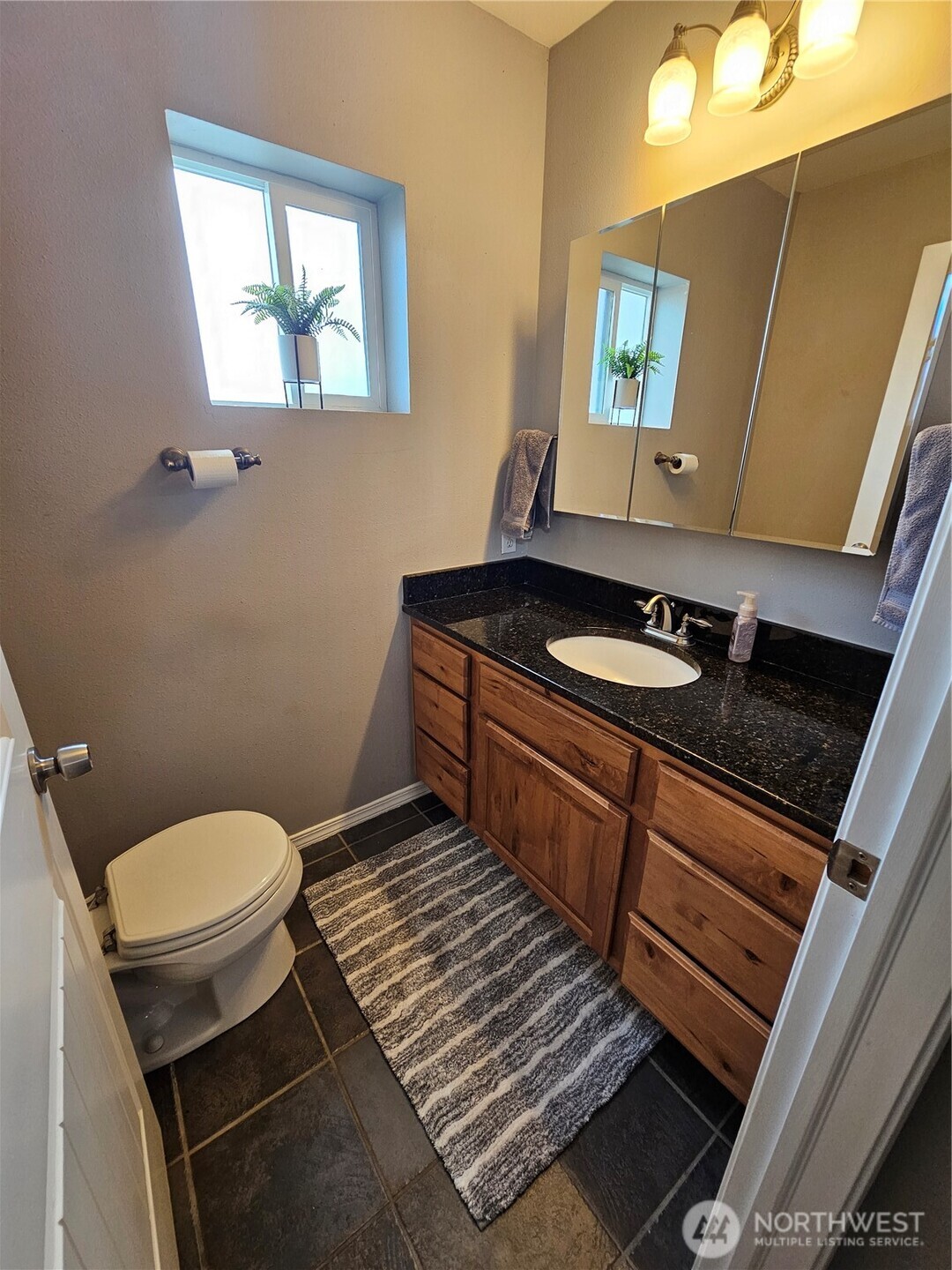 711 Havillah Road Tonasket, WA 98855 - Photo 20 of 40 a bathroom with a toilet a sink and a mirror