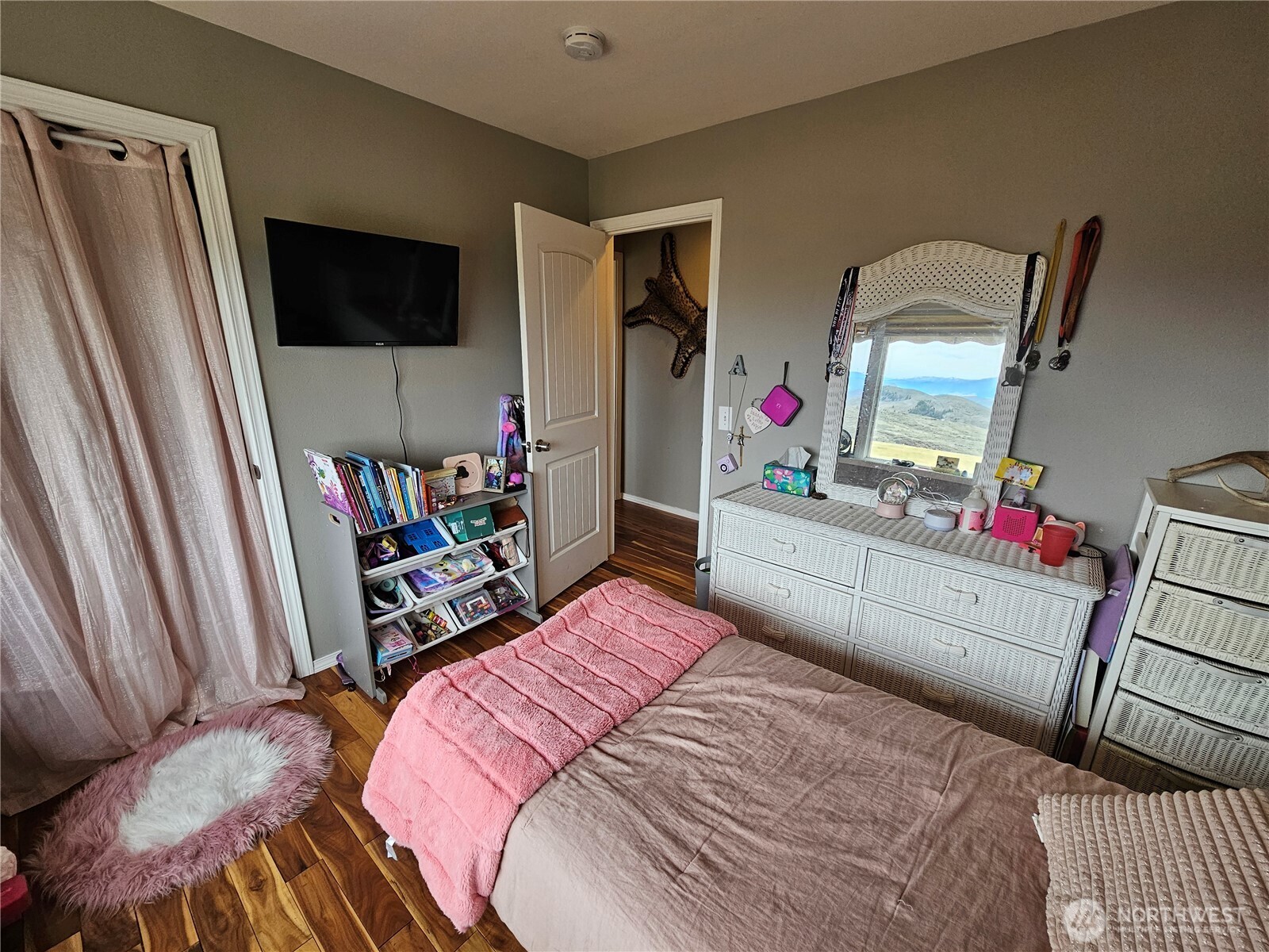711 Havillah Road Tonasket, WA 98855 - Photo 25 of 40 a bedroom with a bed and a flat tv screen on dresser
