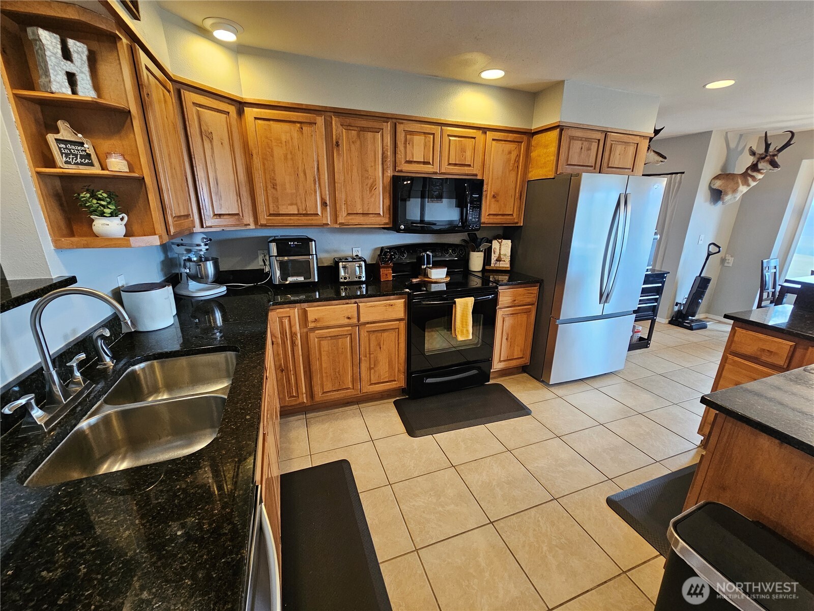 711 Havillah Road Tonasket, WA 98855 - Photo 9 of 40 a kitchen with stainless steel appliances granite countertop a sink a stove and a refrigerator