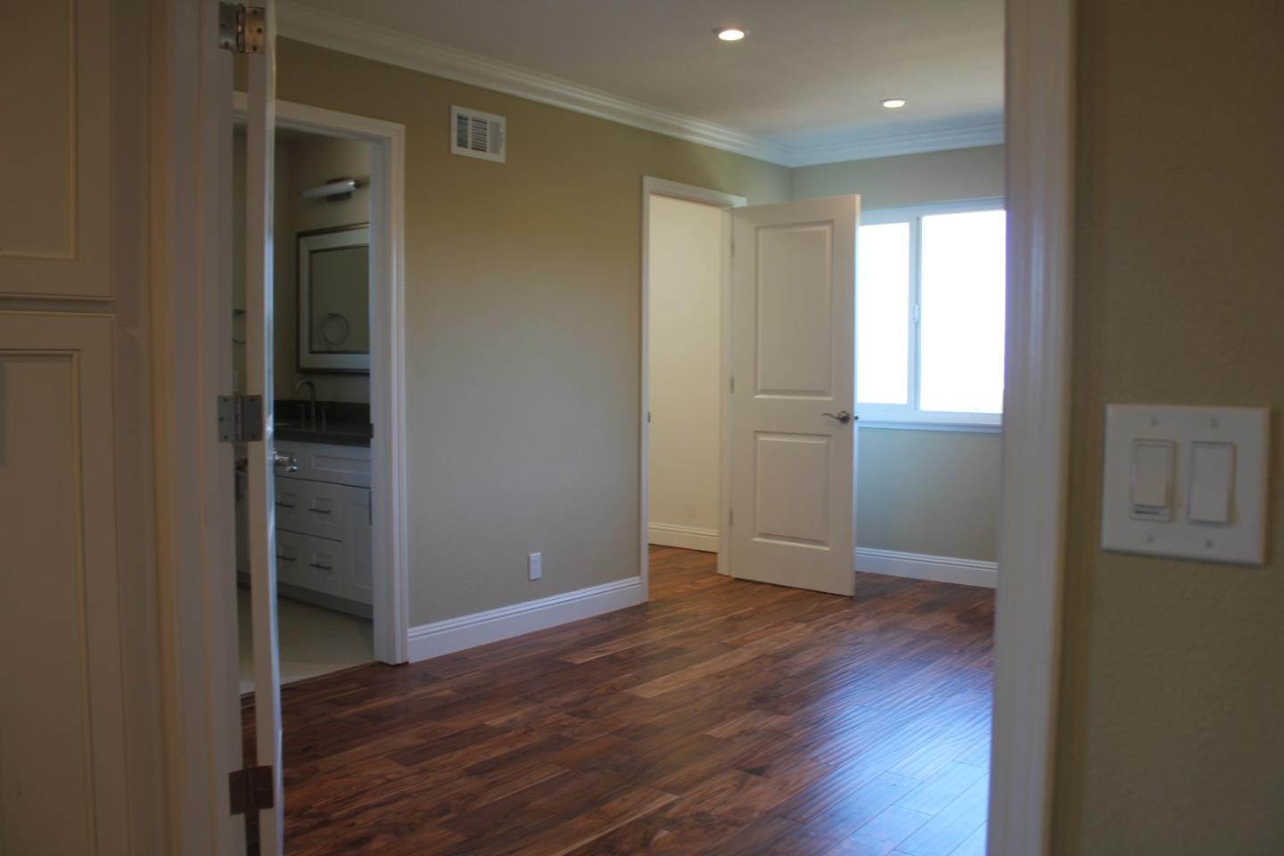 250 Loma Road San Carlos, CA 94070 - Photo 13 of 25 an empty room with wooden floor & windows