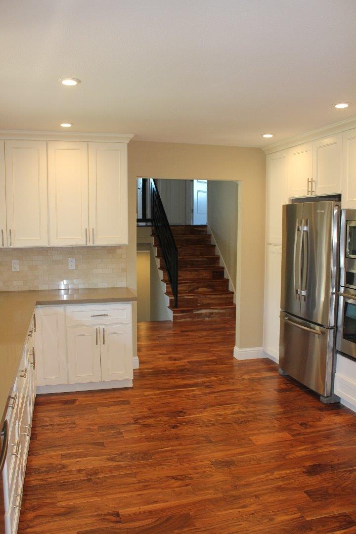 250 Loma Road San Carlos, CA 94070 - Photo 7 of 25 a kitchen with stainless steel appliances granite countertop a refrigerator a stove and a sink with wooden floor
