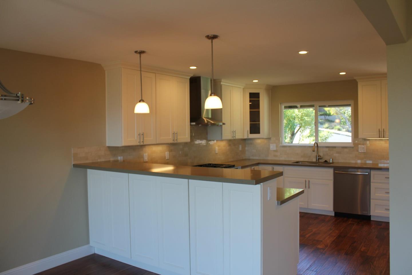 250 Loma Road San Carlos, CA 94070 - Photo 9 of 25 a large kitchen with granite countertop a sink a counter space and stainless steel appliances