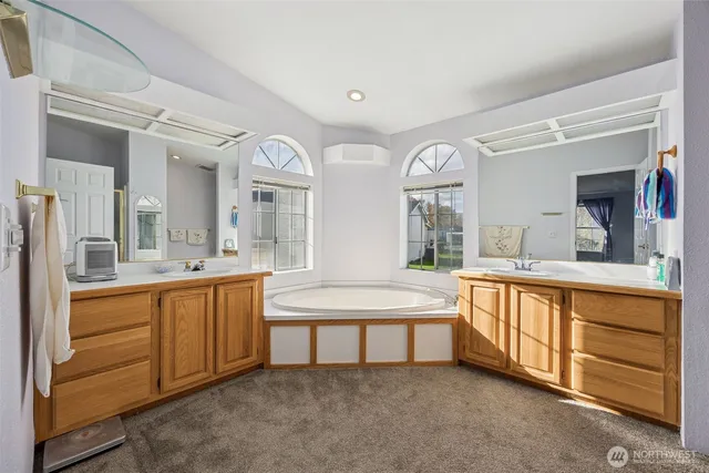 a large bathroom with a large tub and sink