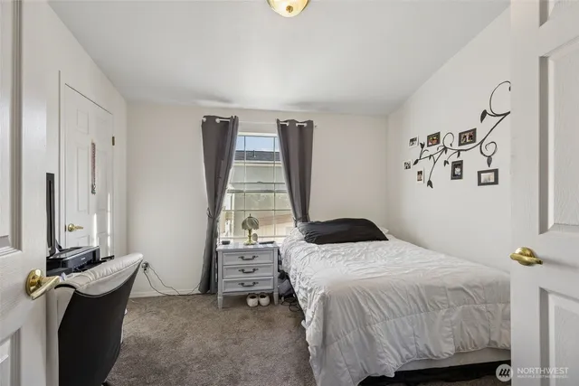 a bedroom with a bed and a table