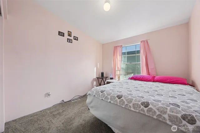 a bedroom with a bed and a window