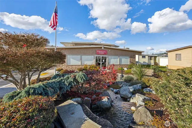 a view of a house with a yard and garden