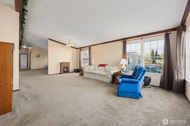 a living room with furniture and a floor to ceiling window