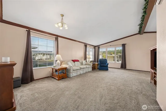 a living room with furniture and a chandelier
