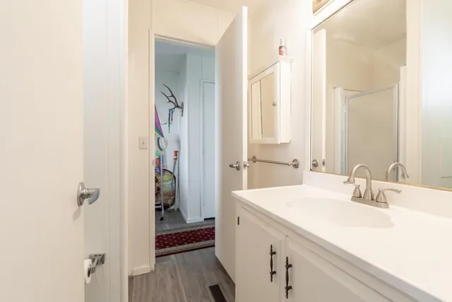 a bathroom with a sink a toilet and shower