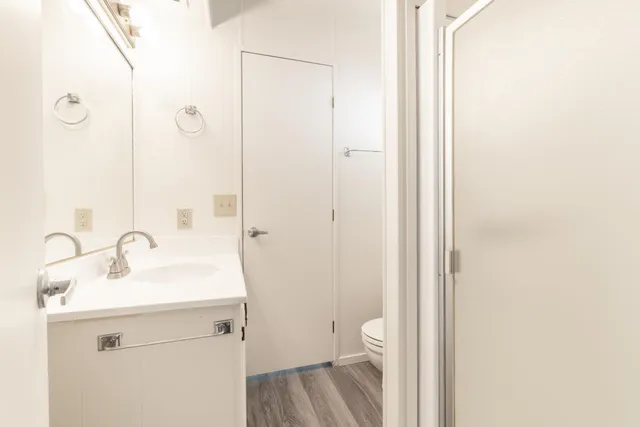 a bedroom with a bed and a dresser in it