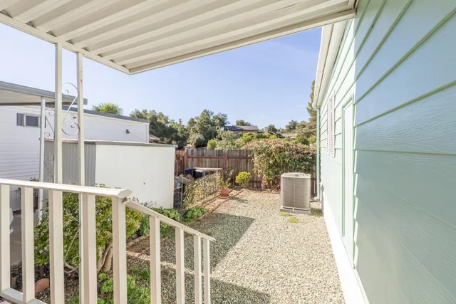 a view of a garden with wooden fence