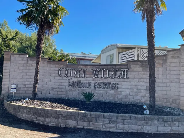 a front view of a house with swimming pool having outdoor seating