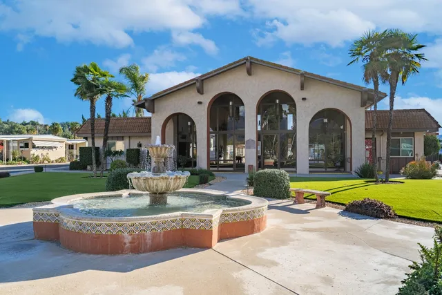a front view of a house with swimming pool having outdoor seating