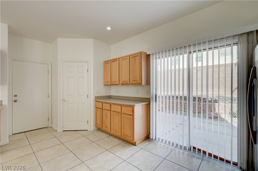 8918 Houston Ridge Avenue Las Vegas, NV 89178 - Photo 7 of 35 A compact kitchen prep area with bright tile flooring and direct patio access.