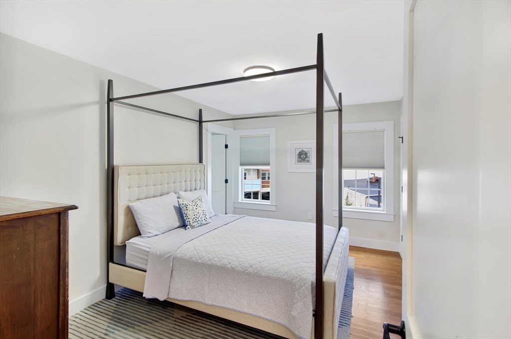 10 Berkley Road, Unit A Hull, MA 02045 - Photo 14 of 25 a bedroom with a bed and a mirror
