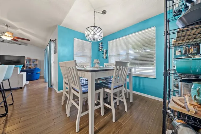 a view of a dining room with furniture wooden floor and a chandelier