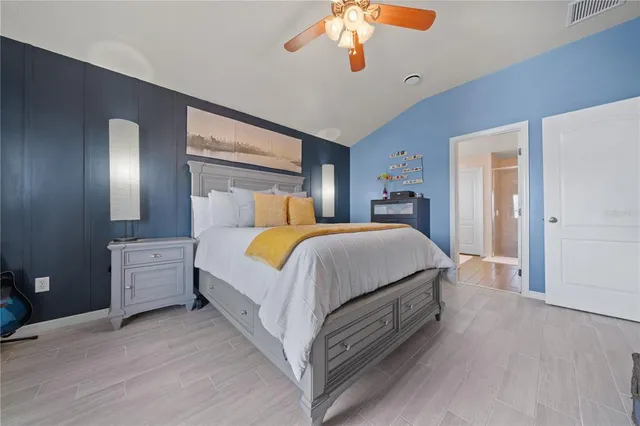 a bed room with a bed and a chandelier