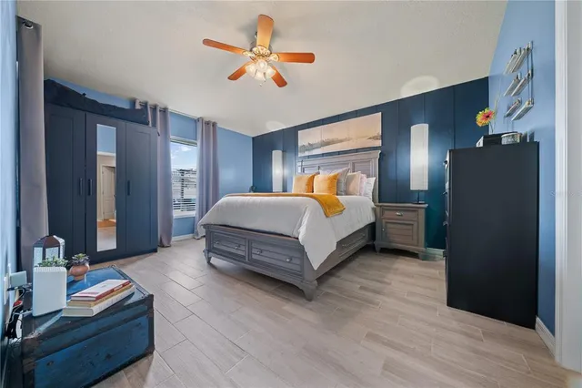 a bedroom with a bed and a chandelier