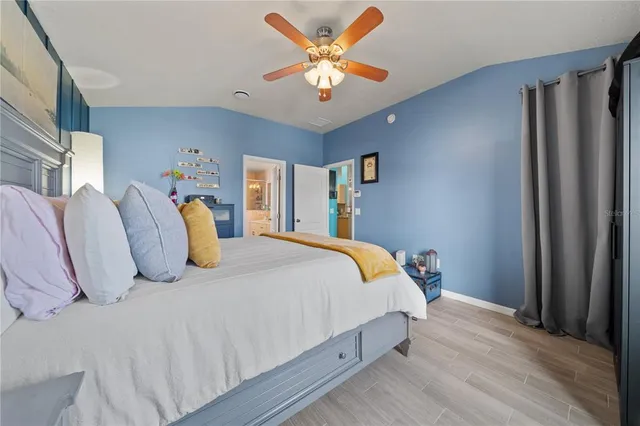 a bedroom with bed and a chandelier