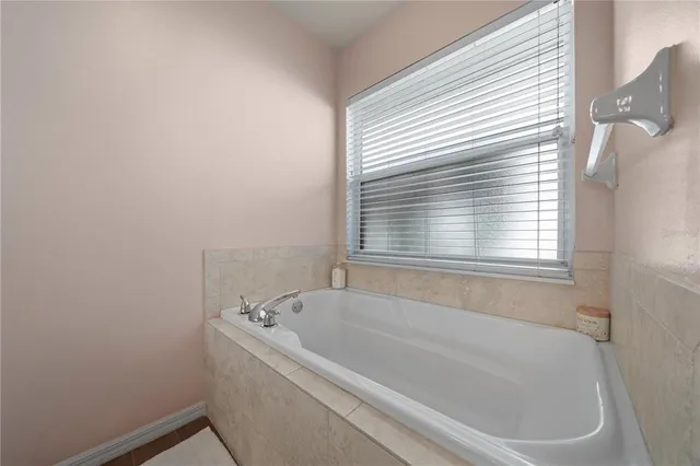 a white bath tub sitting next to a window