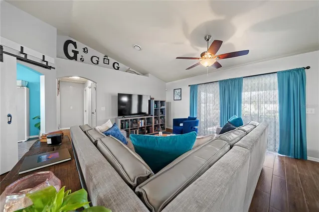 a living room with furniture and a flat screen tv