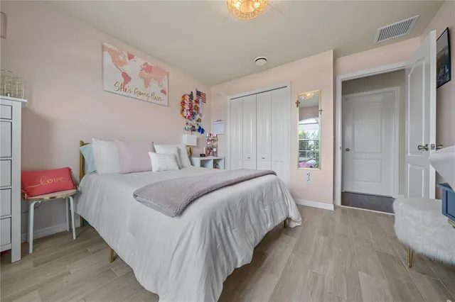 a bedroom with a bed and a painting on the wall