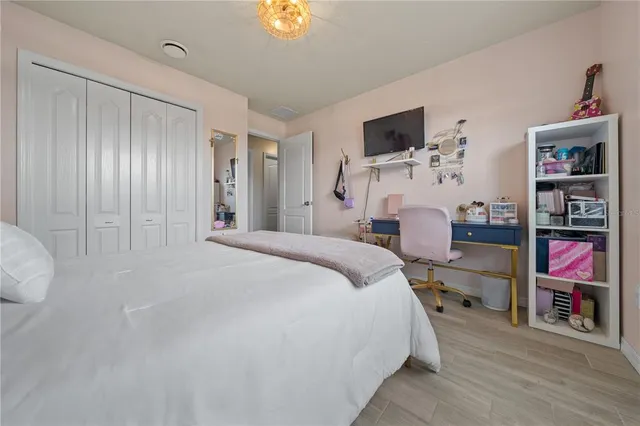 a bedroom with a bed and a flat screen tv