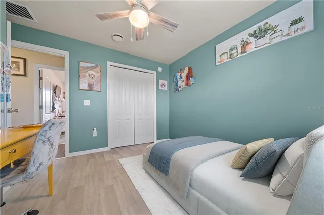 a bedroom with a large bed and a chandelier