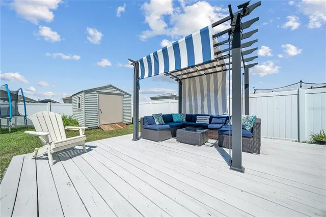 a view of a deck with couches and table with wooden floor