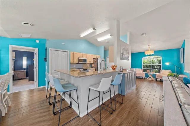 a view of a dining room with furniture and wooden floor
