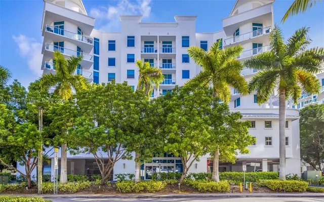 a front view of a multi story building with yard