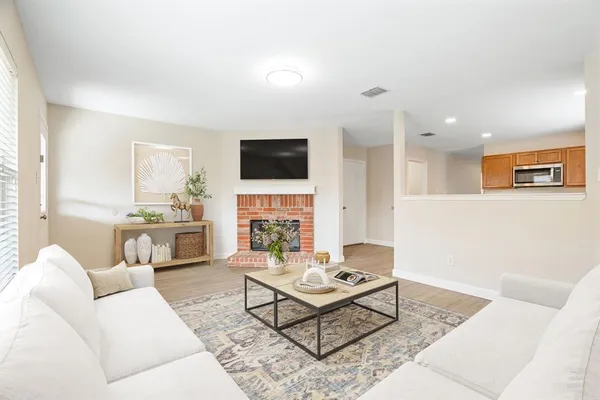 a living room with furniture a fireplace and a flat screen tv