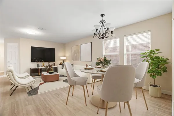 a living room with furniture a flat screen tv and a chandelier