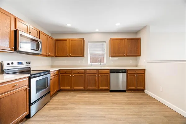 a kitchen with stainless steel appliances granite countertop a stove and a sink