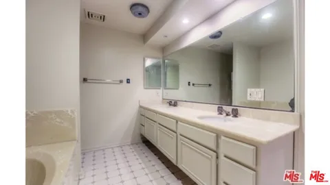 a bathroom with a double vanity sink mirror and