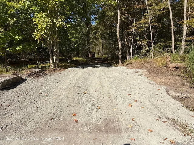 a view of fire pit with large trees
