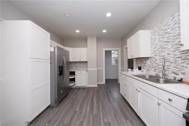a kitchen with stainless steel appliances a refrigerator sink and cabinets