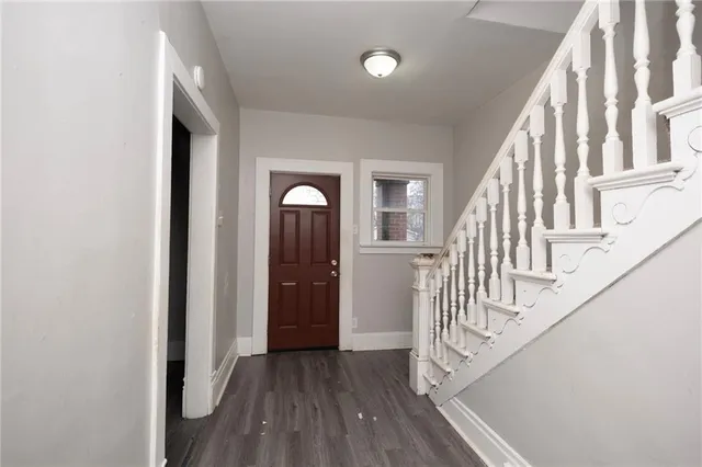 a view of entryway with wooden floor and stairs