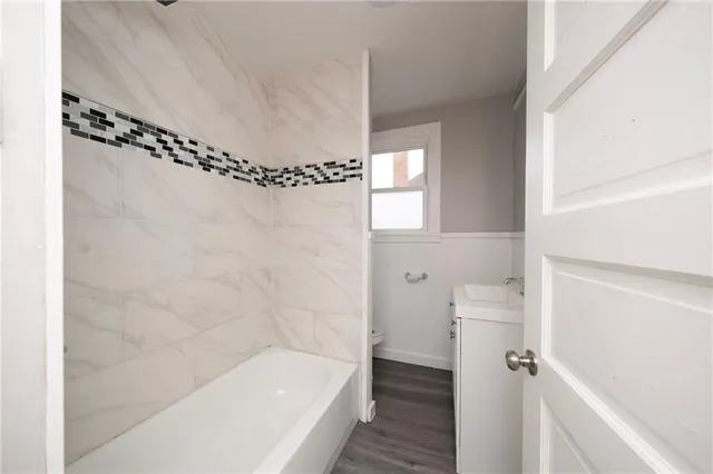 a bathroom with a bathtub and a shower