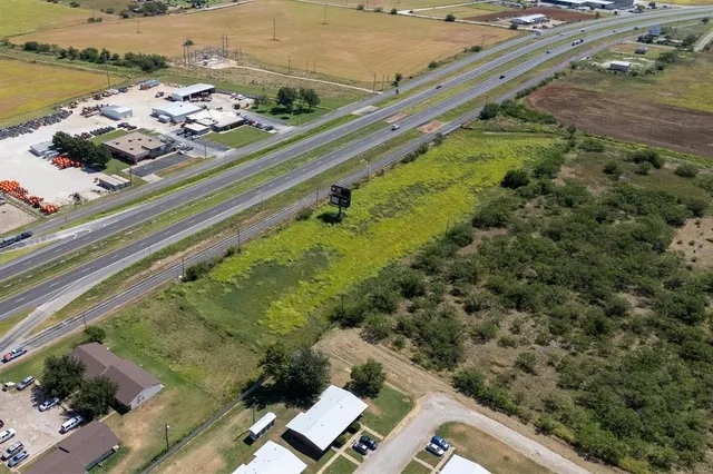 an aerial view of a residential houses with outdoor space