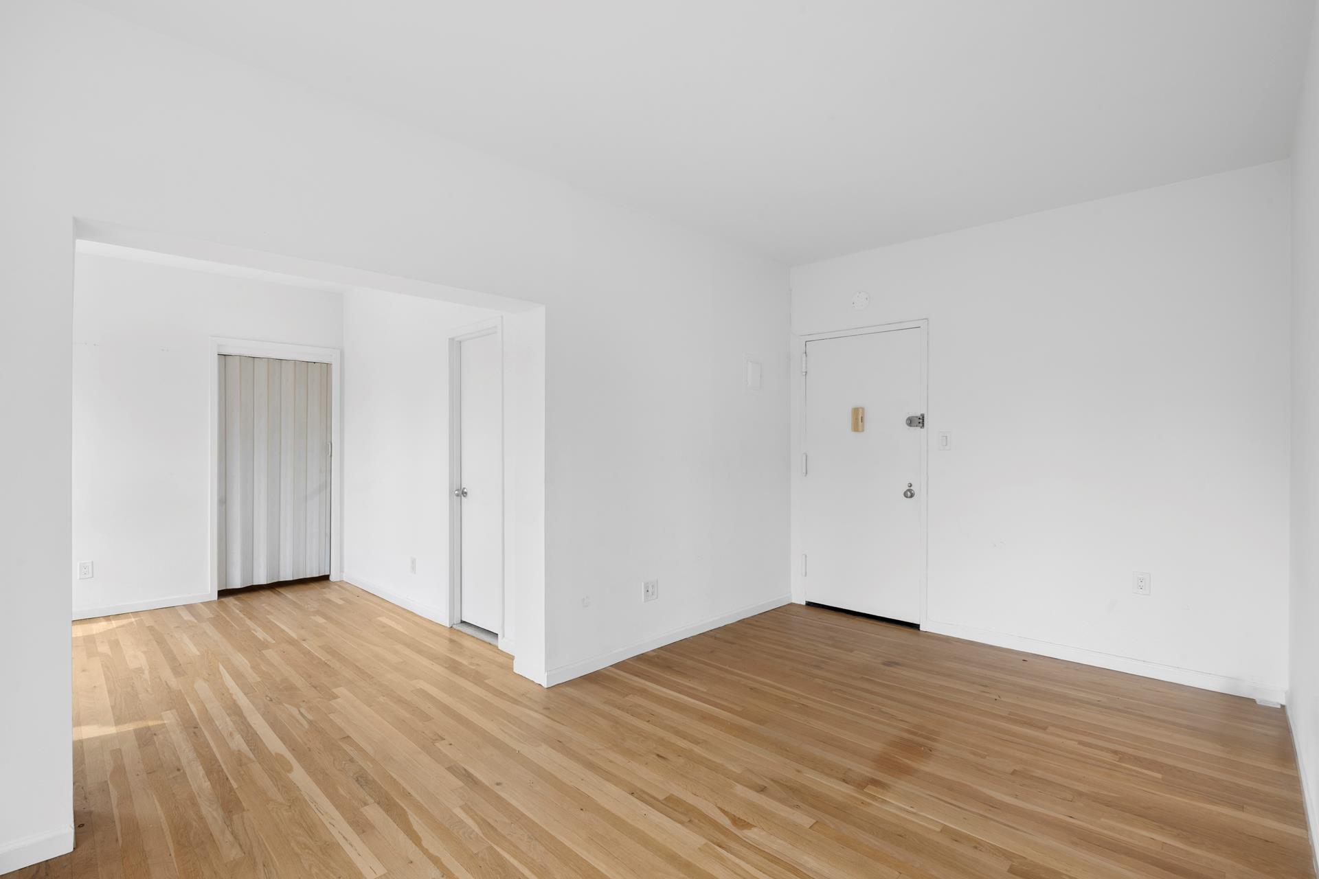 104 West 70th Street, Unit 5F Manhattan, NY 10023 - Photo 6 of 10 a view of an empty room with wooden floor